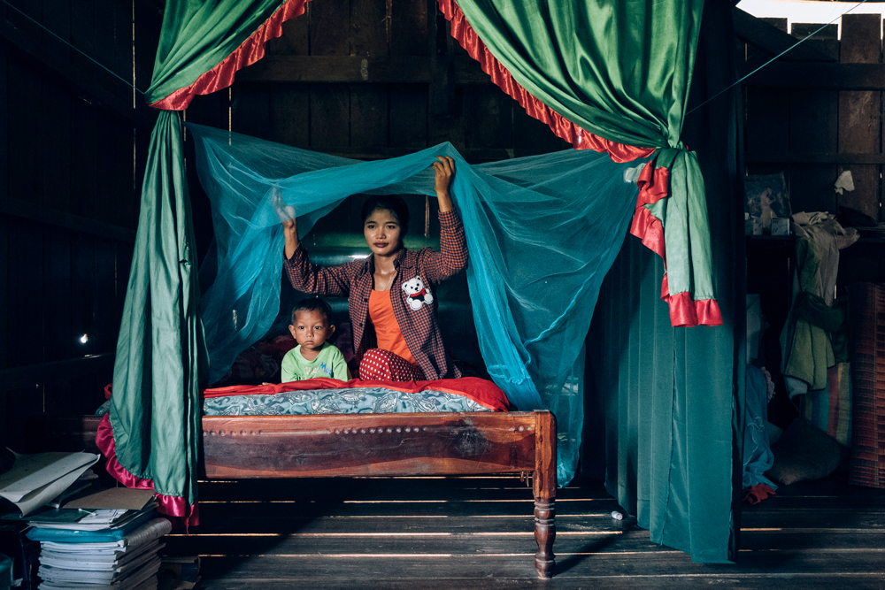 Mother and child under bednet in Cambodia